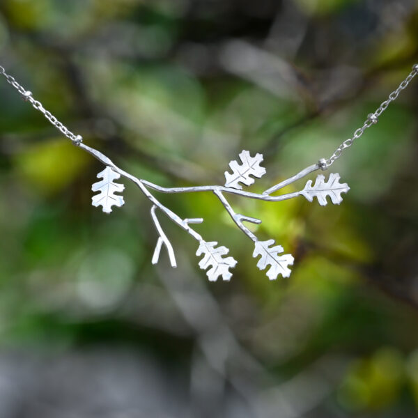 silver necklace in the shape of an oak branch with leaves